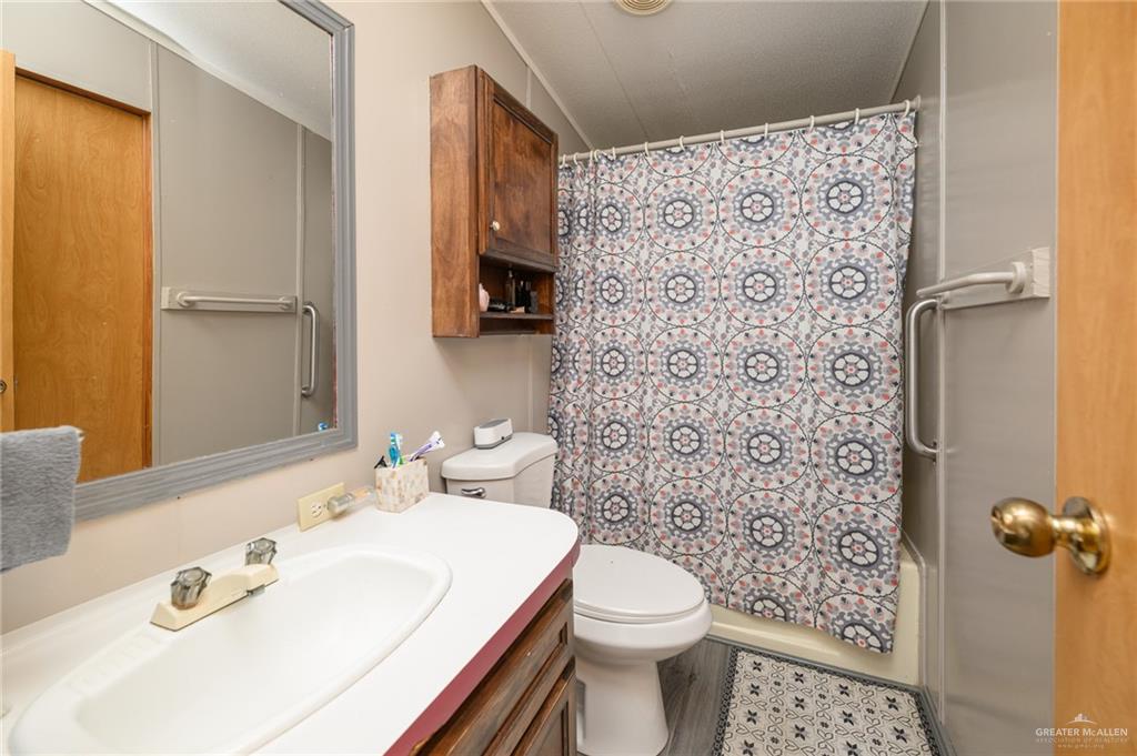 36338 Marshall Hutts Road Rio Hondo, TX 78583 - Photo 25 of 42 a bathroom with a sink toilet and shower