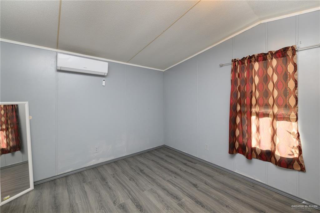 36338 Marshall Hutts Road Rio Hondo, TX 78583 - Photo 29 of 42 a view of a room with wooden floor and fan