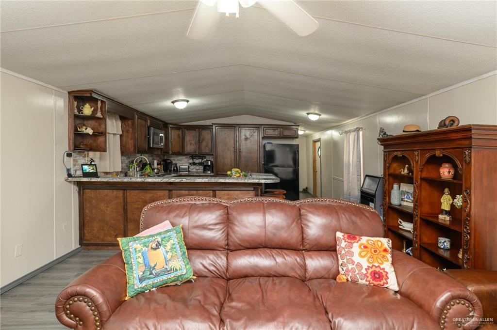 36338 Marshall Hutts Road Rio Hondo, TX 78583 - Photo 4 of 42 a living room with furniture and wooden floor