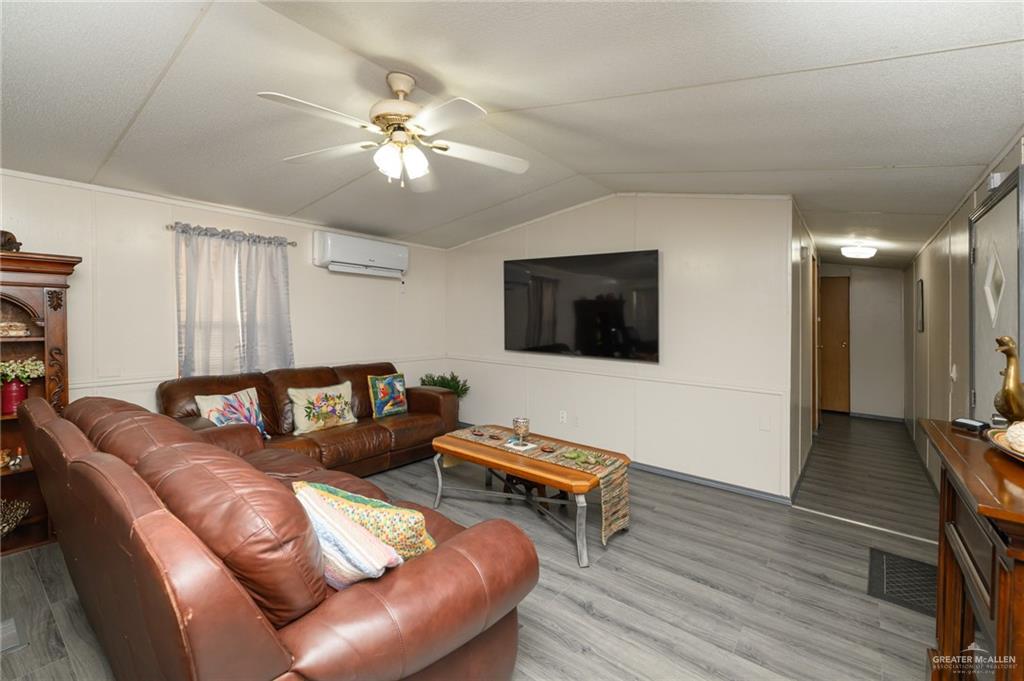 36338 Marshall Hutts Road Rio Hondo, TX 78583 - Photo 5 of 42 a living room with furniture and a wooden floor