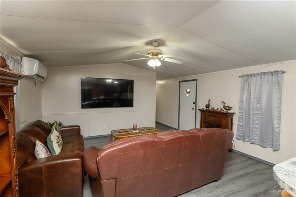 36338 Marshall Hutts Road Rio Hondo, TX 78583 - Photo 6 of 42 a living room with furniture and a flat screen tv