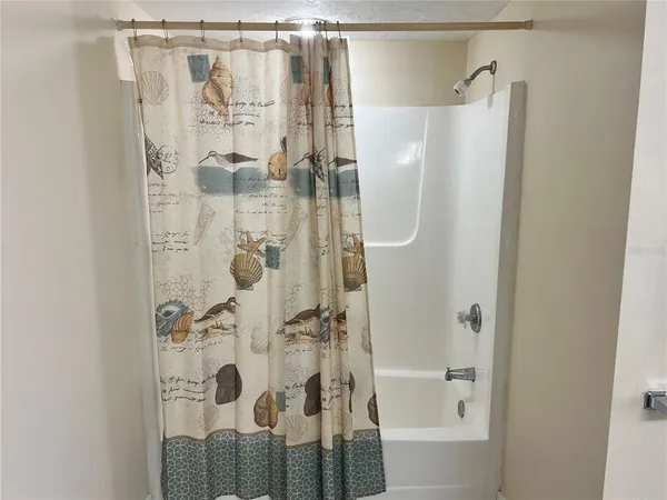 a bathroom with a shower and a sink