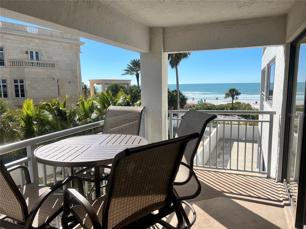 1001 Point Of Rocks Road, Unit 309 Sarasota, FL 34242 - Photo 3 of 38 a view of a patio with table and chairs with wooden floor and fence