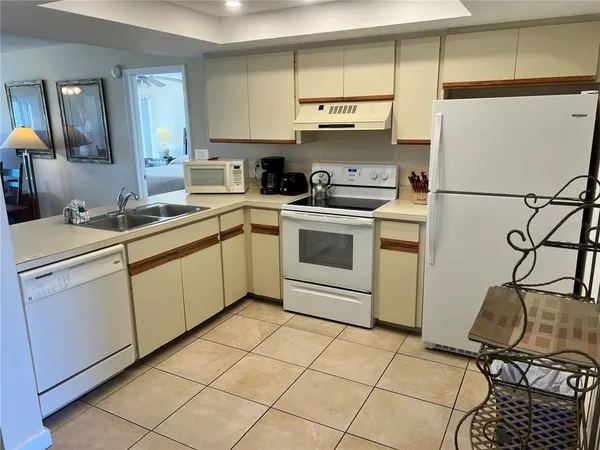 a kitchen with a table chairs and a refrigerator