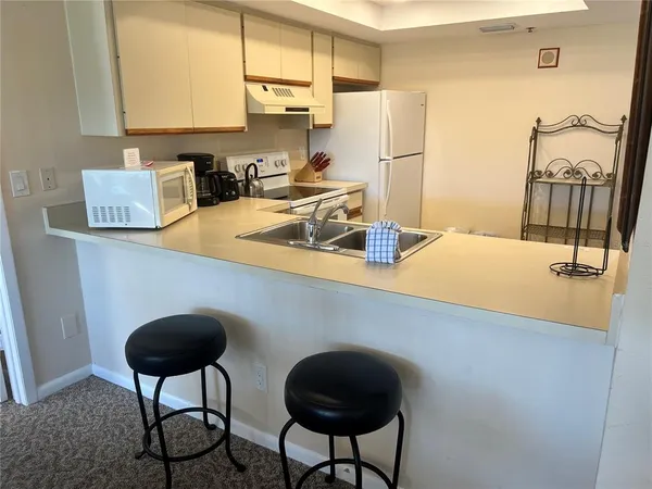 a dining room with furniture a rug and a chandelier