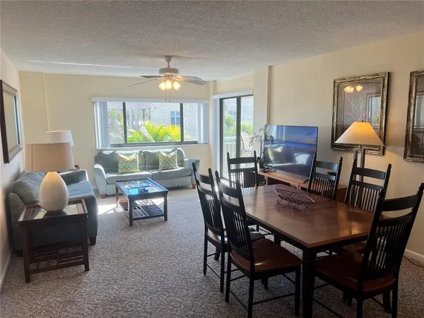 a dining room with furniture and wooden floor
