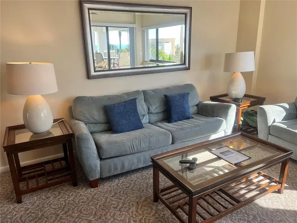 a living room with couch and a large window