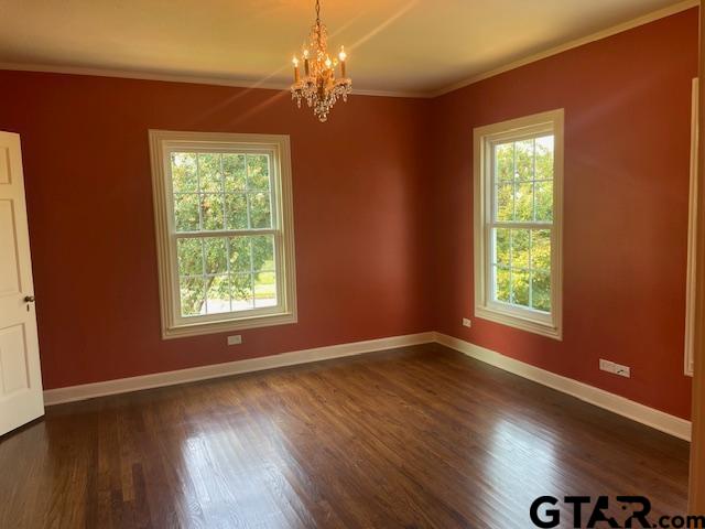 114 East 2nd Street Tyler, TX 75701 - Photo 42 of 48 an empty room with wooden floor chandelier and windows
