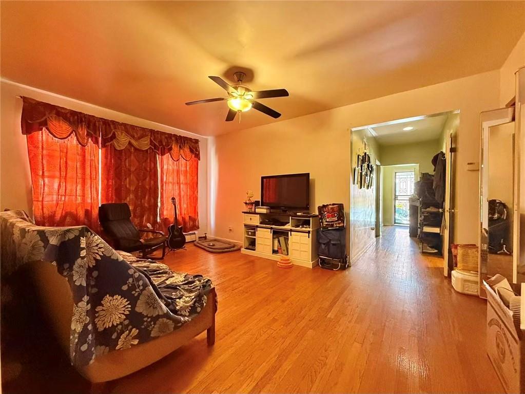 1876 Bay Ridge Avenue Brooklyn, NY 11204 - Photo 12 of 12 a living room with furniture flat screen tv and wooden floor