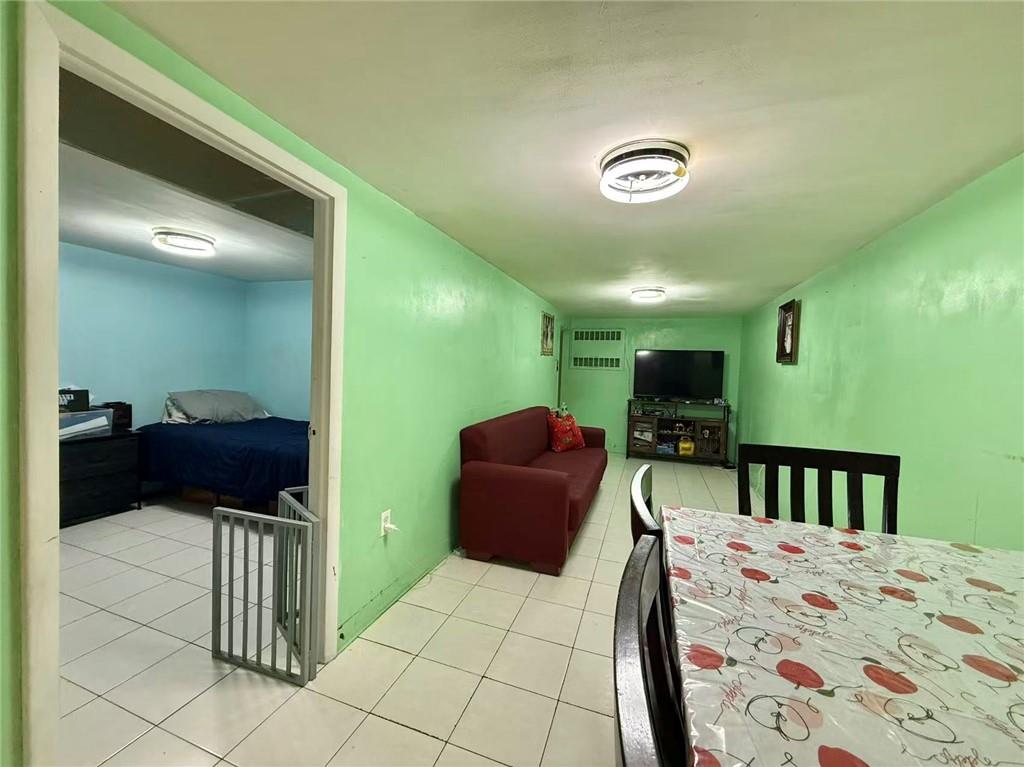 1876 Bay Ridge Avenue Brooklyn, NY 11204 - Photo 2 of 12 a bedroom with a bed and a couch