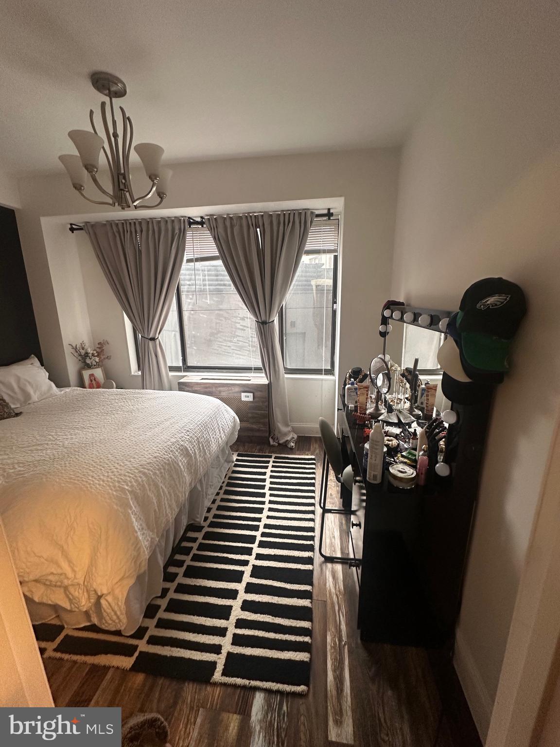 1 Scott Circle Northwest, Unit 118 Washington, DC 20036 - Photo 42 of 54 a bedroom with a bed and wooden floor