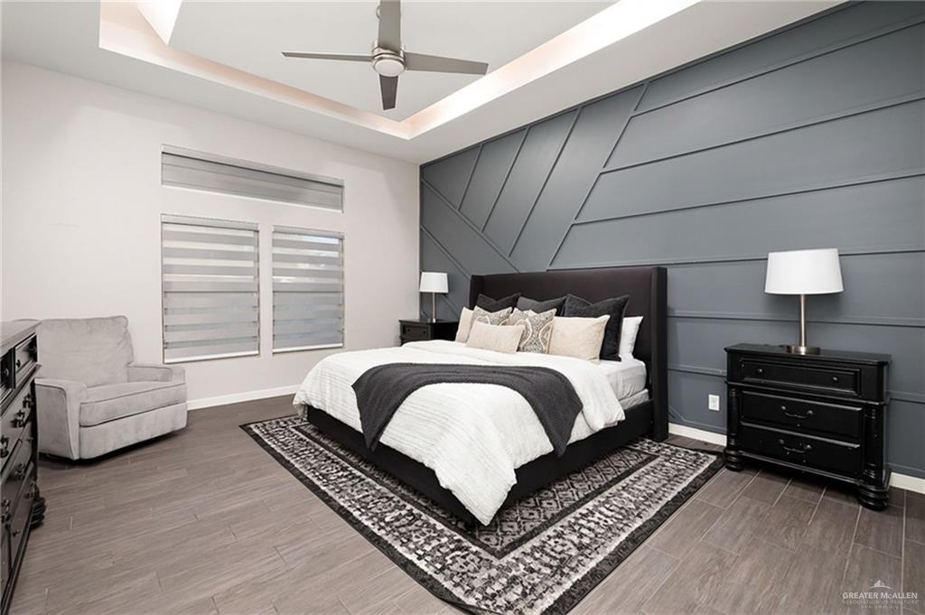 1014 Hill Country Road Edinburg, TX 78539 - Photo 12 of 31 a bedroom with a bed a couch and a chandelier