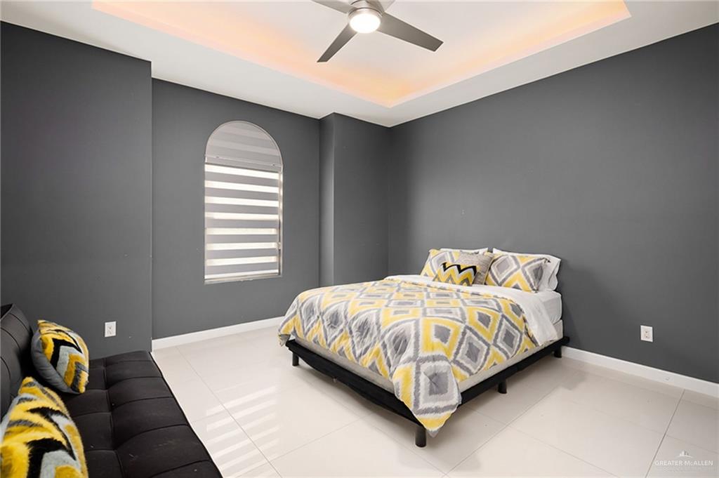 1014 Hill Country Road Edinburg, TX 78539 - Photo 17 of 31 a bed sitting in a bedroom next to a window