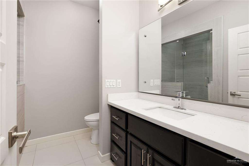 1014 Hill Country Road Edinburg, TX 78539 - Photo 18 of 31 a bathroom with a sink a toilet a shower and a mirror