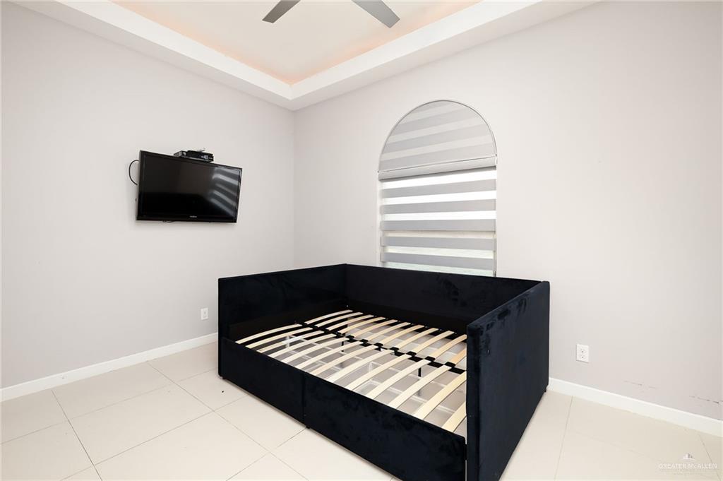 1014 Hill Country Road Edinburg, TX 78539 - Photo 28 of 31 a bedroom with a bed and a flat screen tv