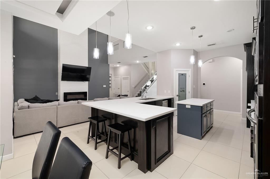 1014 Hill Country Road Edinburg, TX 78539 - Photo 6 of 31 a kitchen with a stove a refrigerator and a microwave