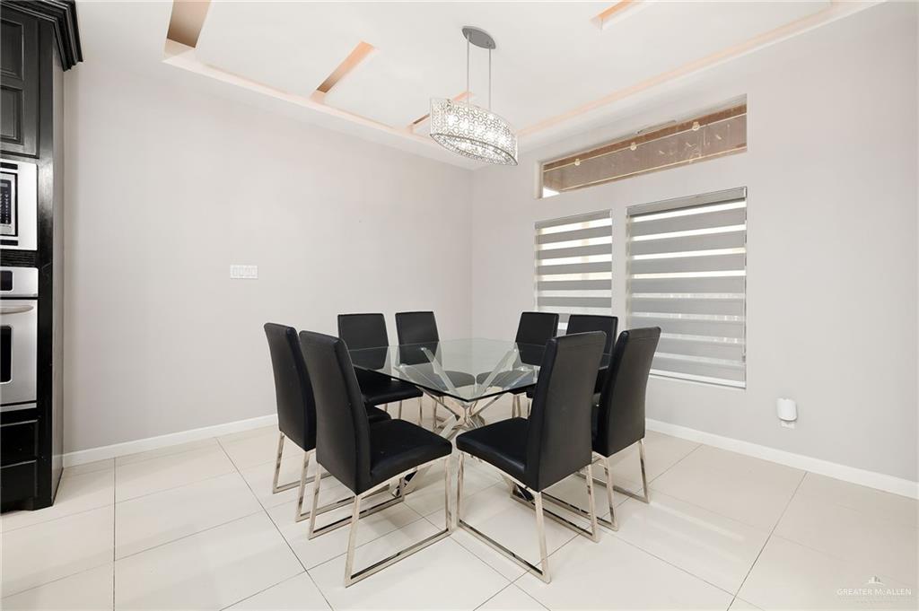 1014 Hill Country Road Edinburg, TX 78539 - Photo 8 of 31 a view of a dining room with furniture and chandelier