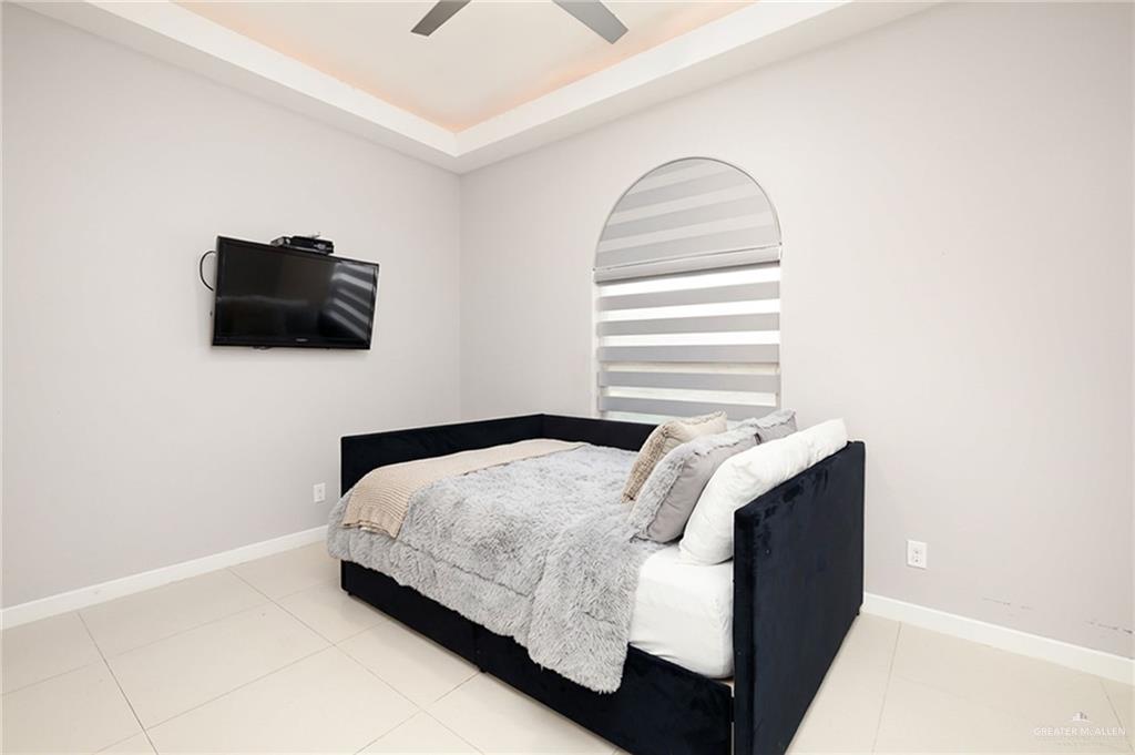 1014 Hill Country Road Edinburg, TX 78539 - Photo 9 of 31 a bedroom with a bed and a flat screen tv