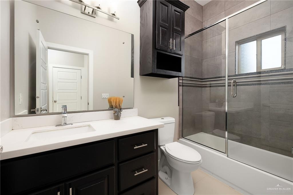 1014 Hill Country Road Edinburg, TX 78539 - Photo 10 of 31 a bathroom with a sink a toilet and shower