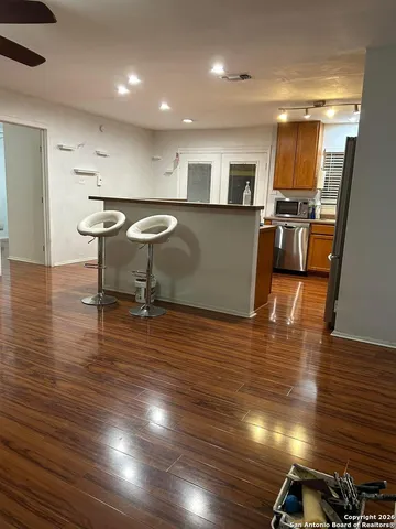 a living room with lots of furniture and a wooden floor