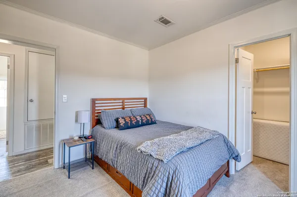 a bedroom with a bed and a cabinets