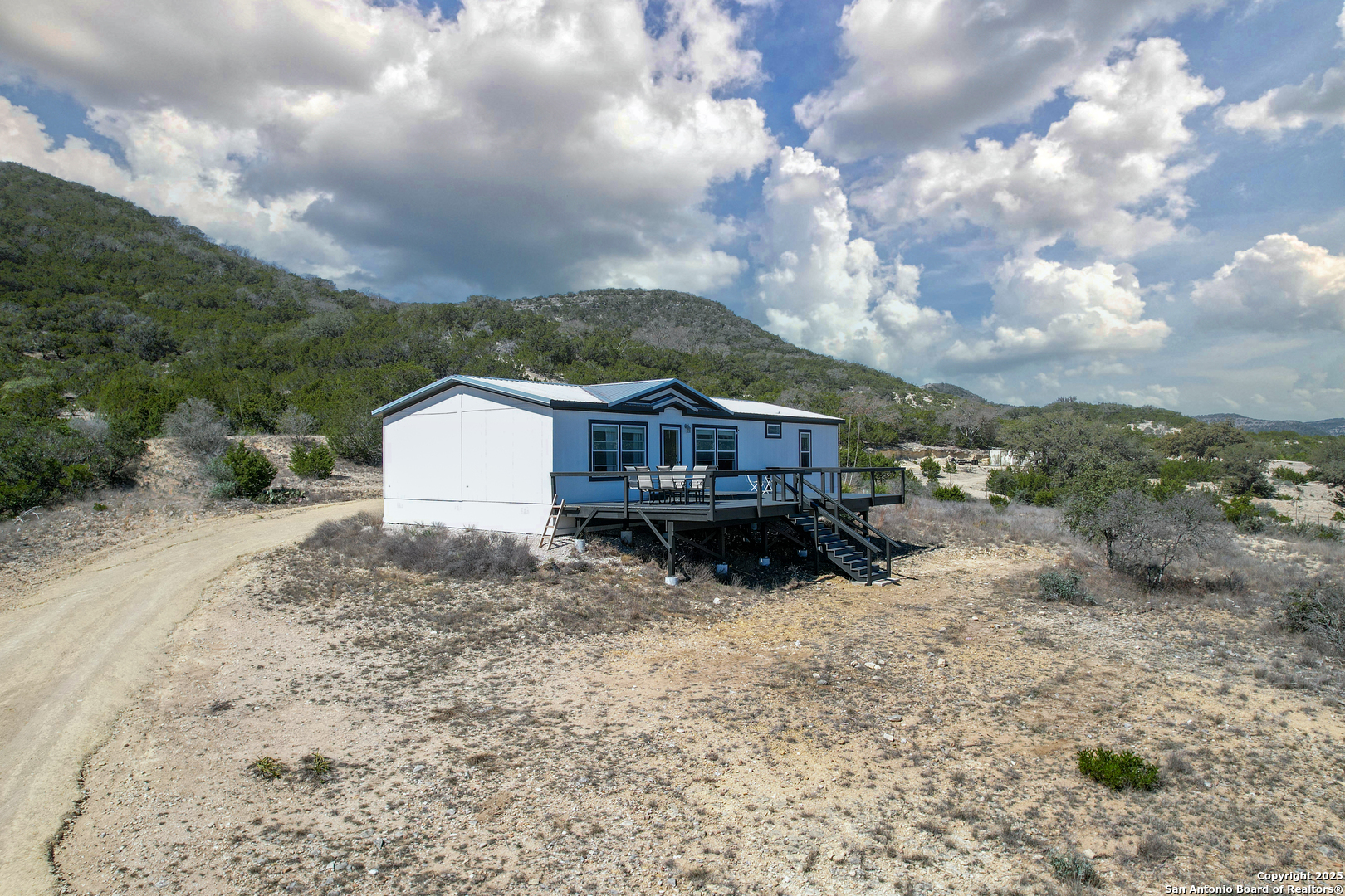 3049 North Little Creek Road Utopia, TX 78884 - Photo 6 of 38 a view of a house with a yard