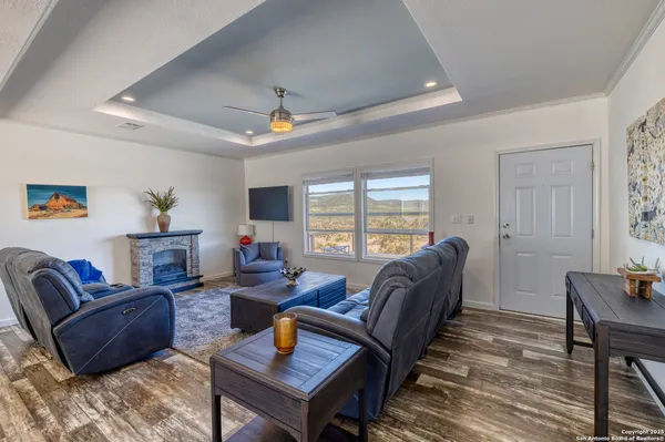 a living room with furniture a fireplace and a table