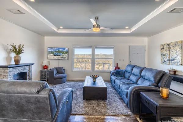 a living room with furniture fireplace and window