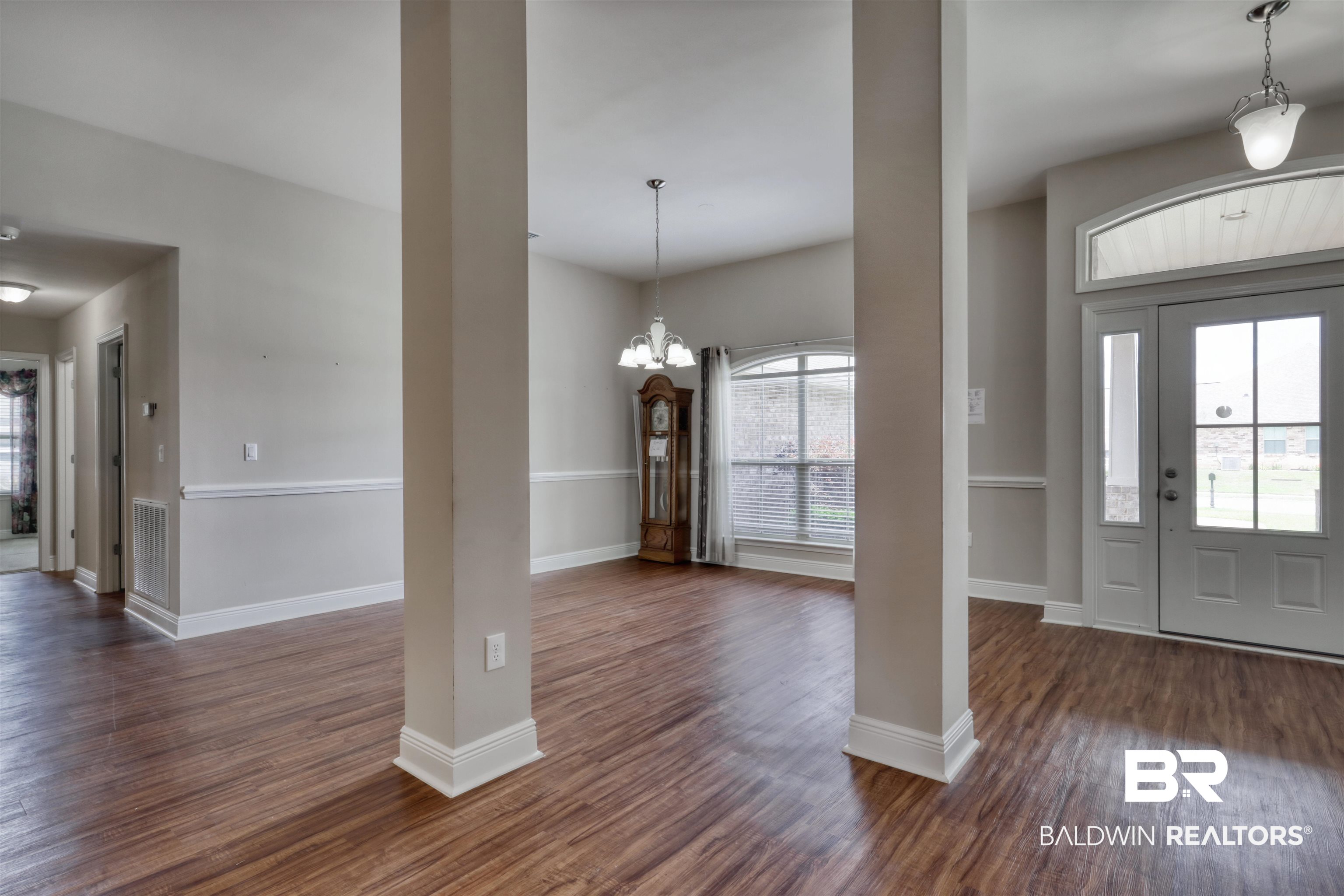 14794 Troon Drive Foley, AL 36535 - Photo 4 of 33 Entryway with baseboards, dark wood-style flooring, a notable chandelier, and decorative columns