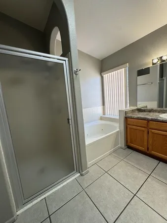 a bathroom with a bathtub and a shower
