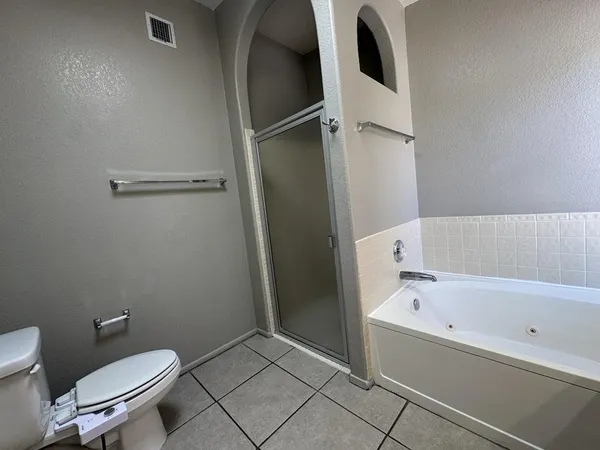 a bathroom with a toilet and a bathtub