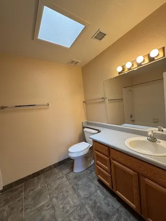 a bathroom with a sink a toilet and mirror
