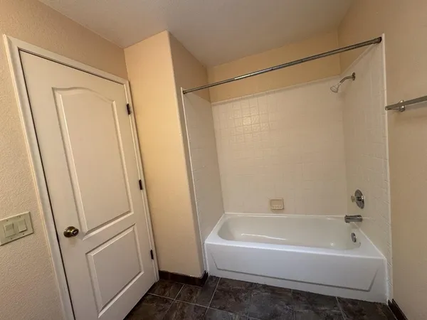 a bathroom with a bathtub and a shower