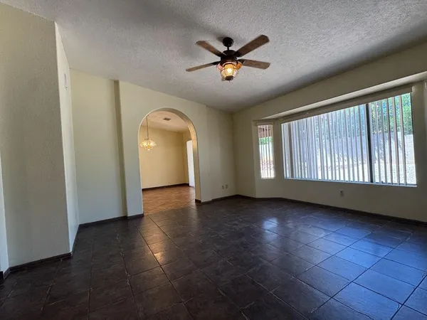 a view of a livingroom with a ceiling fan and window