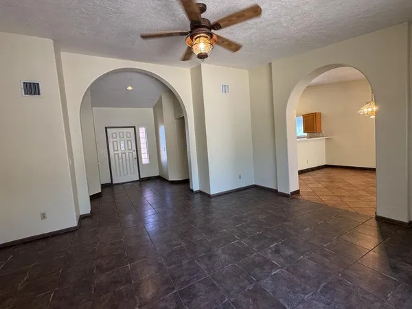 a view of a livingroom with wooden floor and a ceiling fan