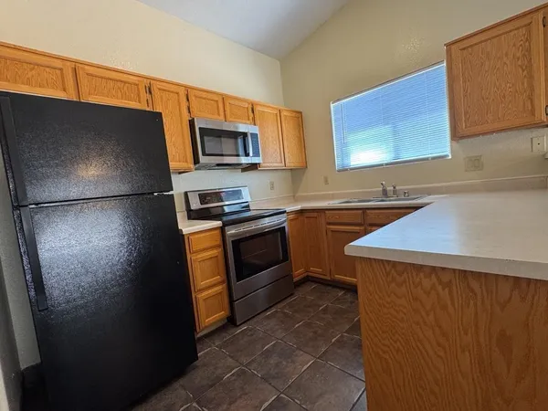 a kitchen with a refrigerator sink and stove top oven