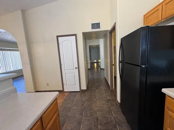 a view of a kitchen from a hallway