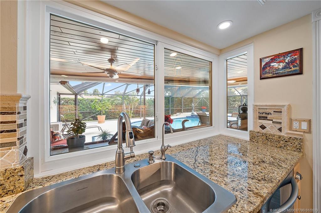 8 North River Road Stuart, FL 34996 - Photo 13 of 42 a kitchen view with granite countertop a sink and a counter top space