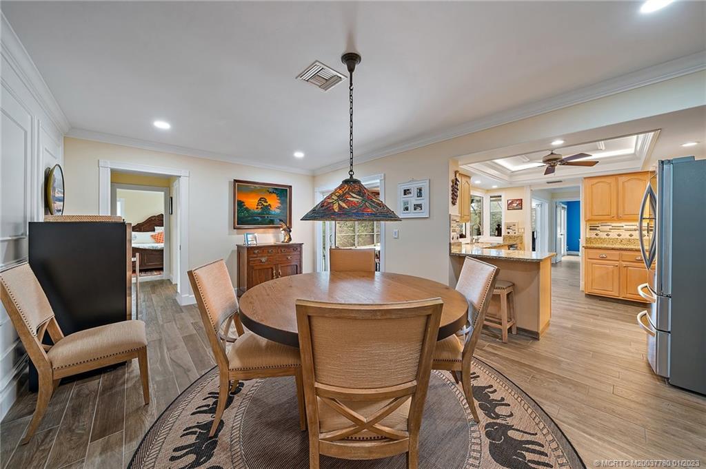 8 North River Road Stuart, FL 34996 - Photo 16 of 42 a dining room with furniture and wooden floor