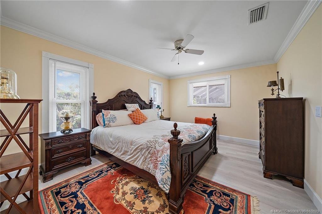 8 North River Road Stuart, FL 34996 - Photo 18 of 42 a bedroom with bed and wooden floor