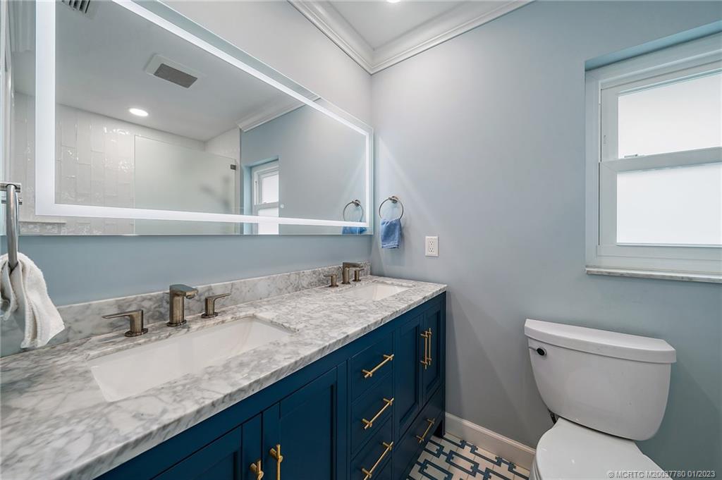 8 North River Road Stuart, FL 34996 - Photo 24 of 42 a bathroom with a granite countertop toilet sink and mirror