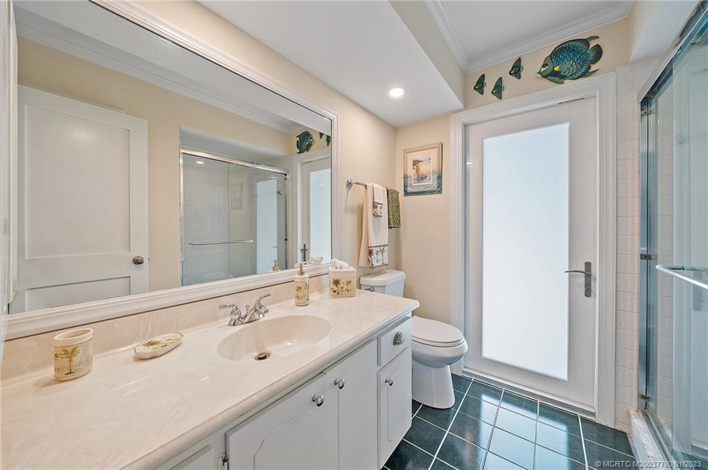 8 North River Road Stuart, FL 34996 - Photo 29 of 42 a spacious bathroom with a double vanity sink and a mirror