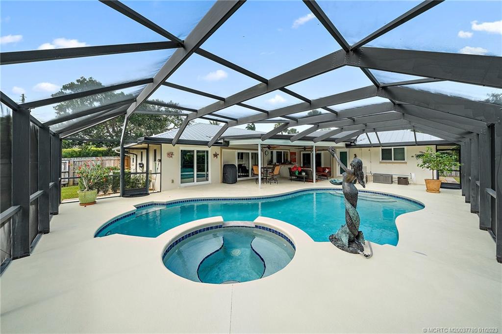 8 North River Road Stuart, FL 34996 - Photo 3 of 42 a swimming pool with outdoor seating and yard