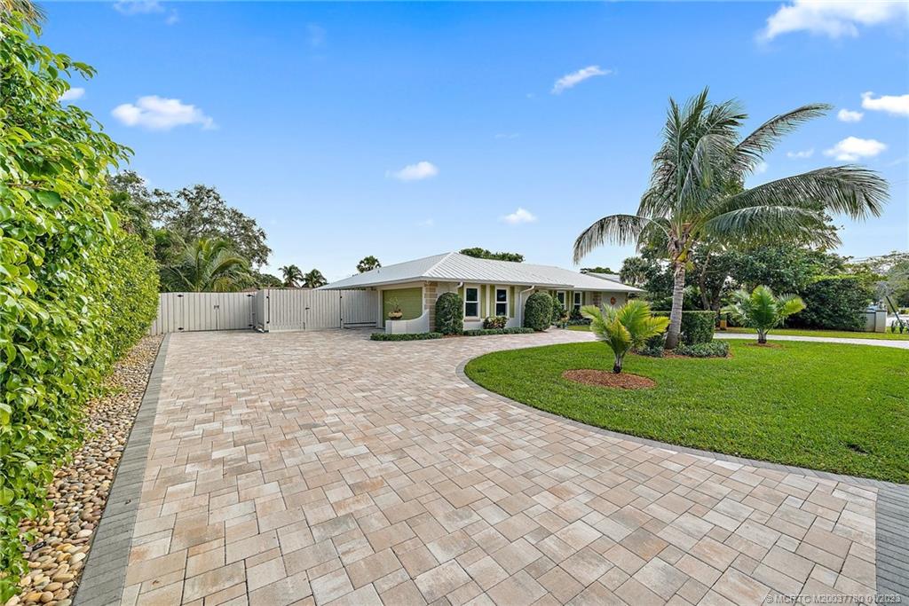 8 North River Road Stuart, FL 34996 - Photo 31 of 42 a front view of a house with a yard