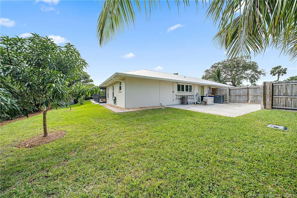 8 North River Road Stuart, FL 34996 - Photo 35 of 42 a view of a house with a backyard and a patio
