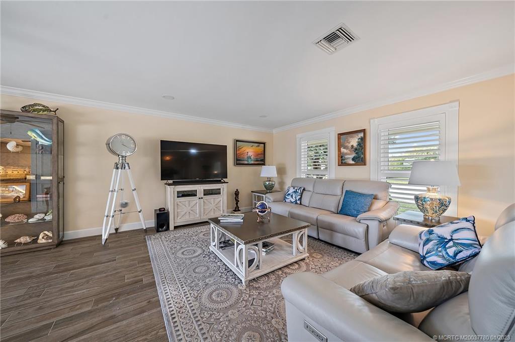 8 North River Road Stuart, FL 34996 - Photo 7 of 42 a living room with furniture and a flat screen tv