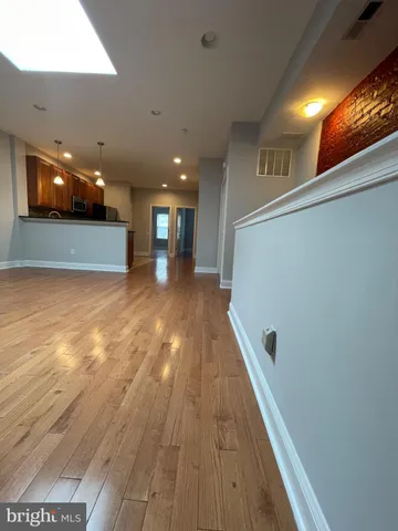 a view of a hallway with wooden floor