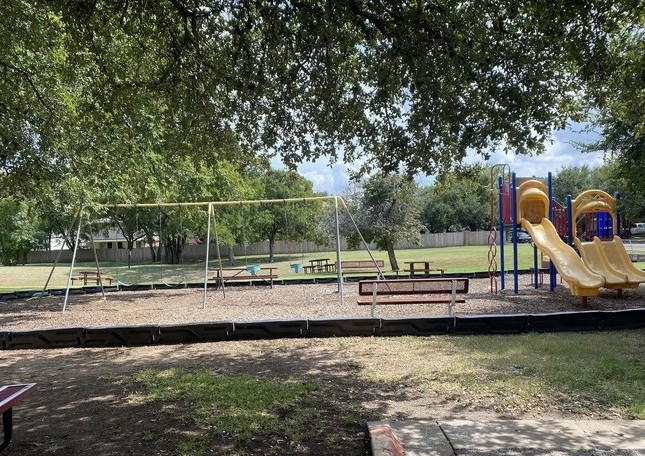 2120 Jester Farms Road Round Rock, TX 78664 - Photo 27 of 28 A vibrant playground set amidst mature trees, offering slides, swings, and picnic areas for outdoor enjoyment.