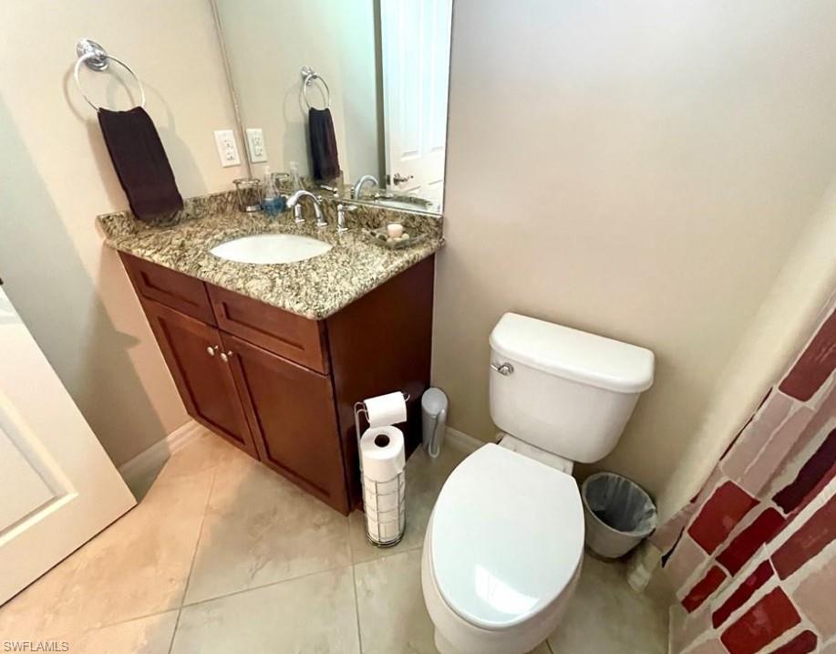 9050 Capistrano Street North, Unit 4102 Naples, FL 34113 - Photo 12 of 31 a bathroom with a toilet sink and mirror