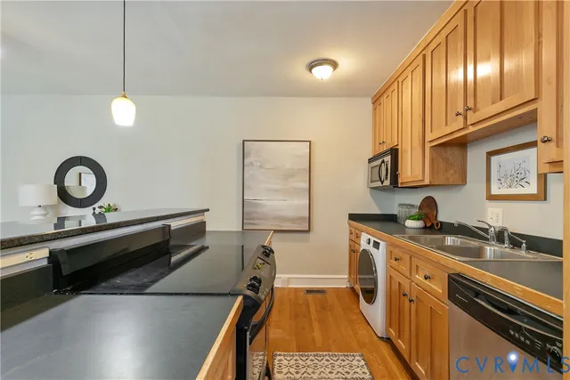 a kitchen with a sink a stove and cabinets